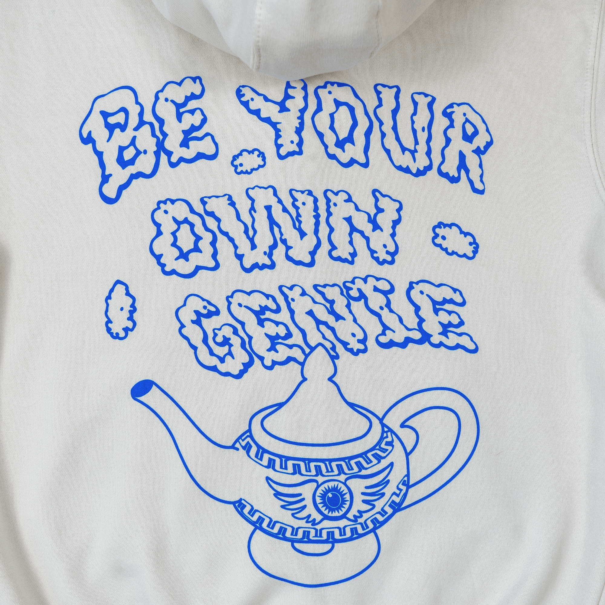 Close-up of genie lamp and smoke lettering design on hoodie back.