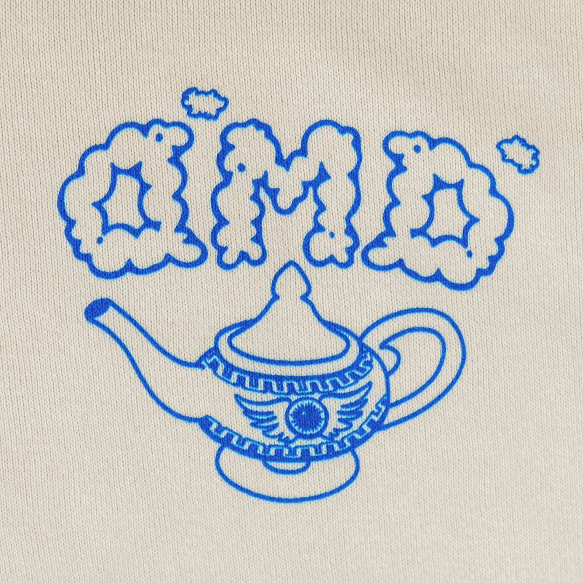 Close-up of DMD chest logo with genie lamp in blue ink.