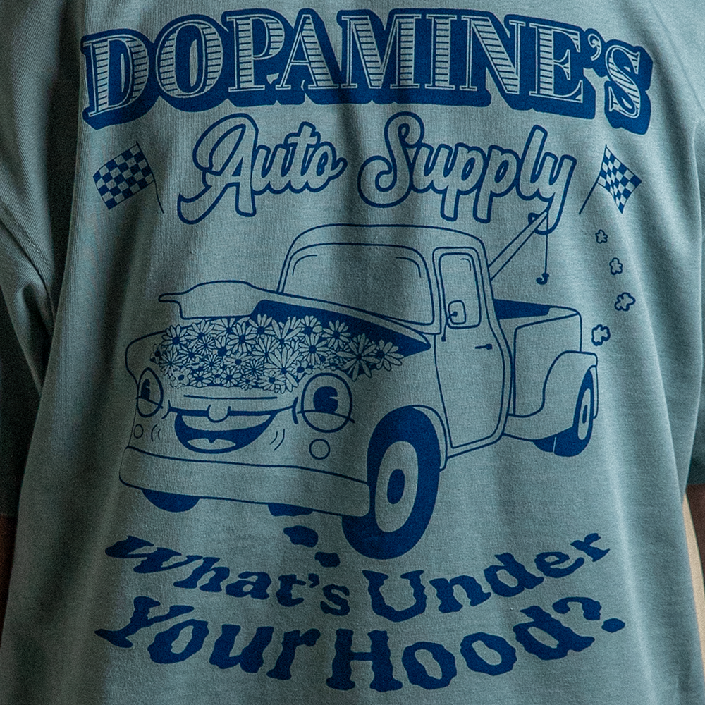 Close up back view of model wearing What's Under Your Hood Heavy Core Tee with oversized back design.