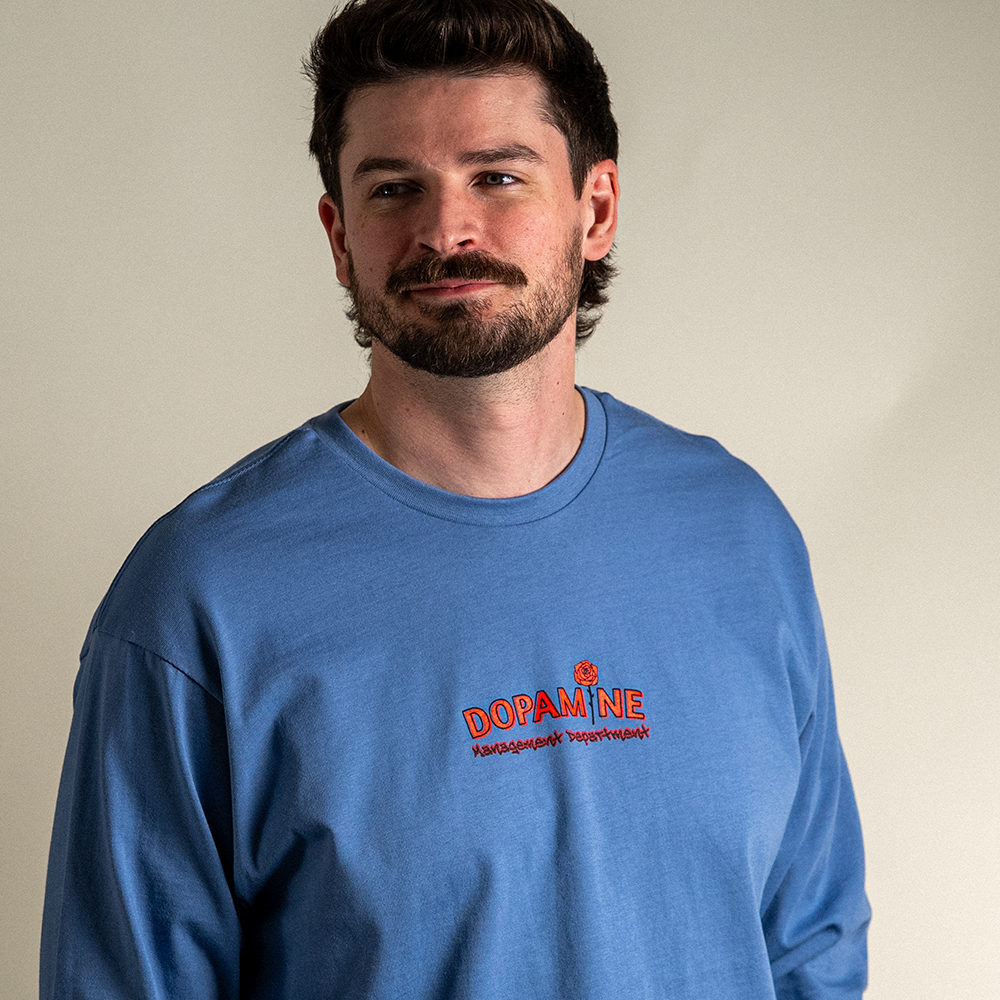 Model smiling in blue Kindness Long Sleeve Tee – unisex streetwear fit