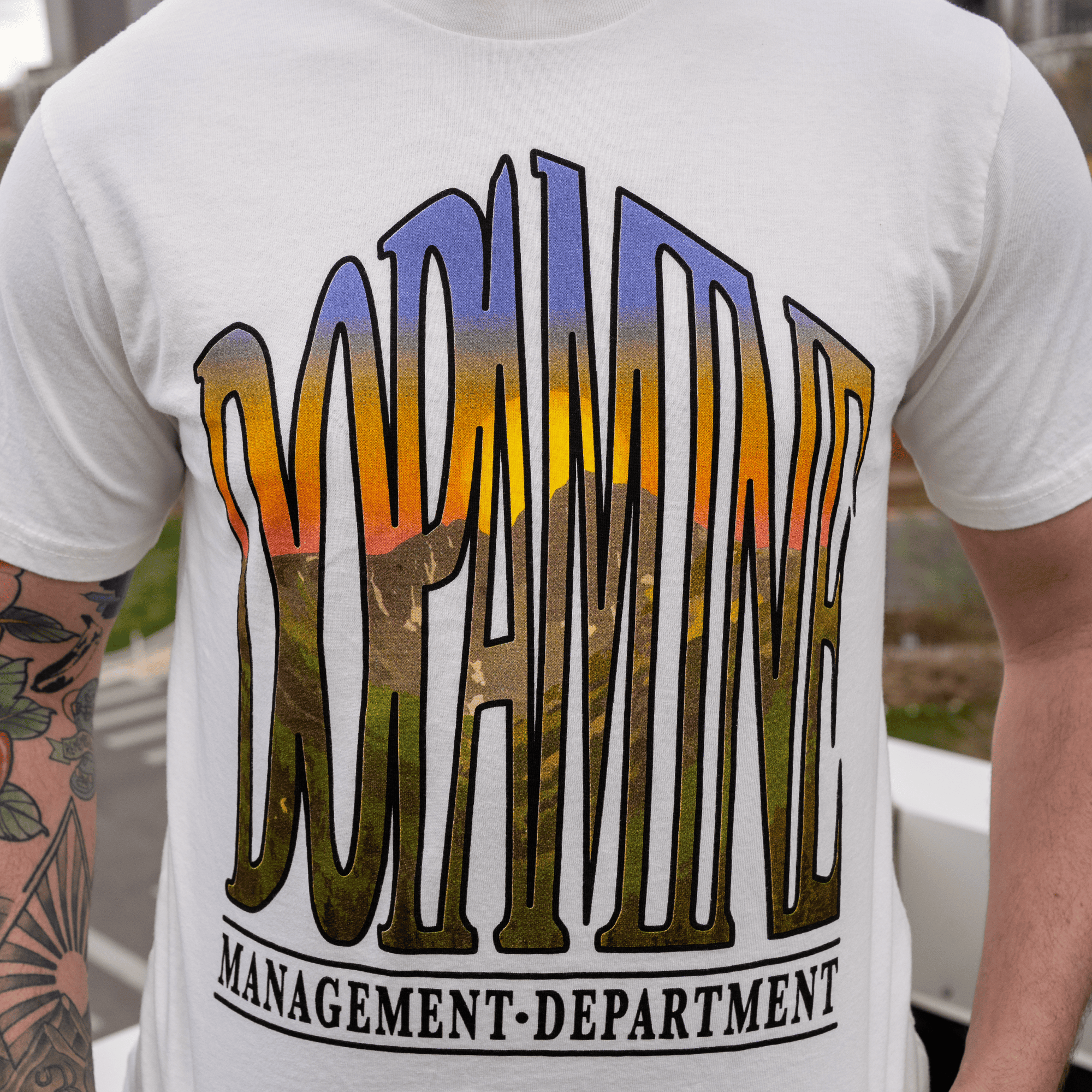 Close-up of Sunrise Design on Unisex Off-White Tee