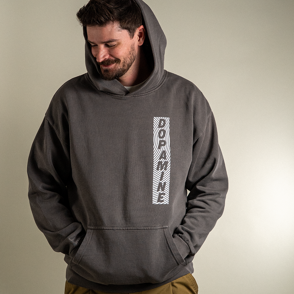 Front view of model wearing Rose heavyweight hoodie with hood up.