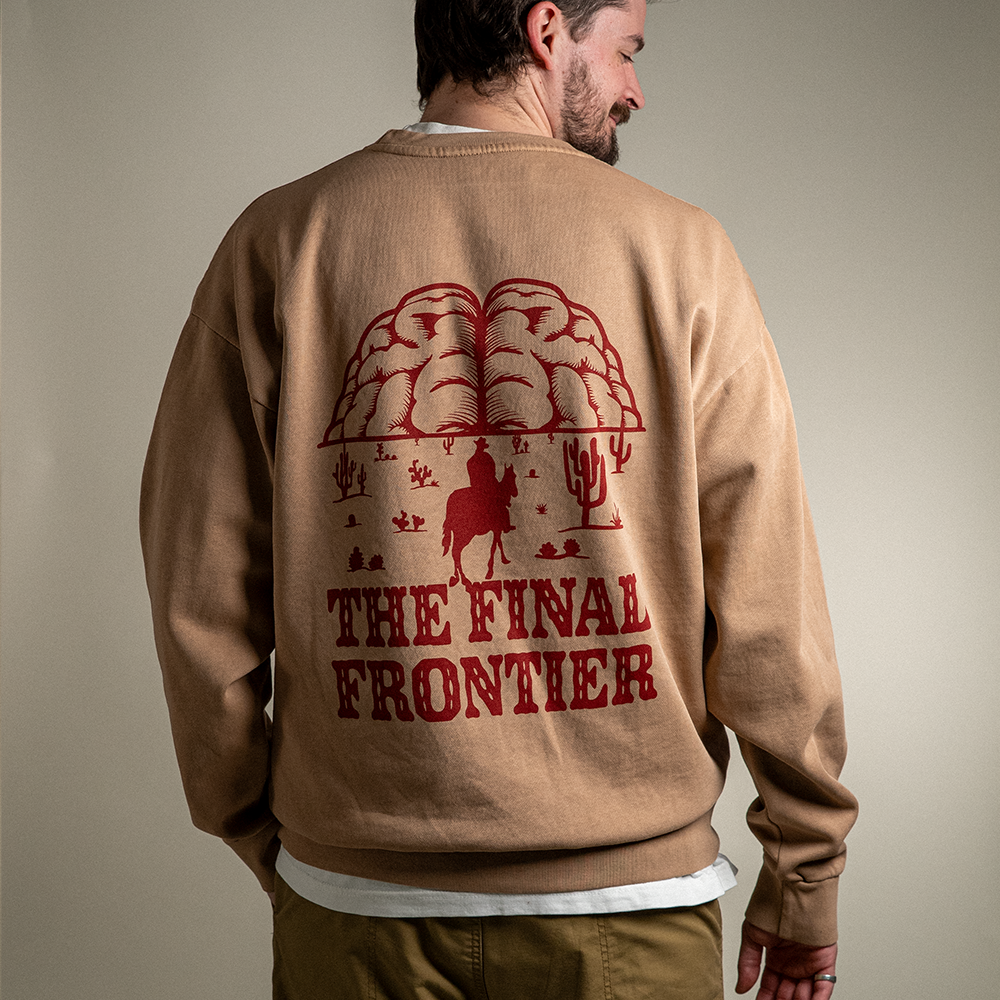 Back view of model in heavyweight crewneck showing red “The Final Frontier” graphic design
