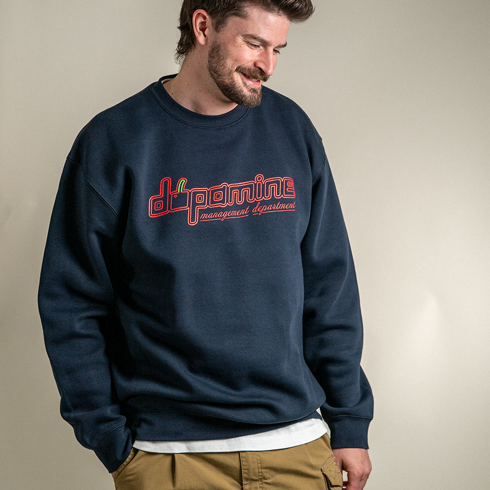 Model smiling in Dopamine Management Department cherry logo sweatshirt