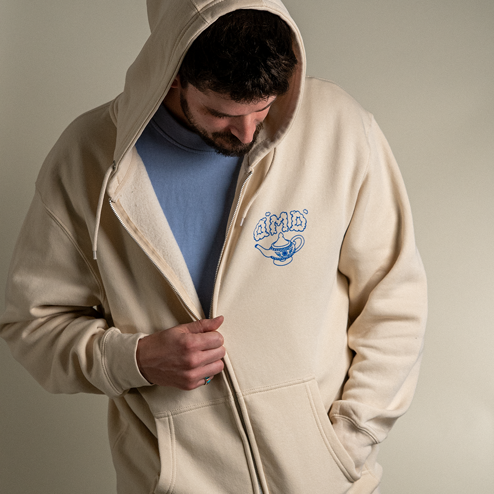 Front view of model wearing Be Your Own Genie zip up hoodie with hood up.