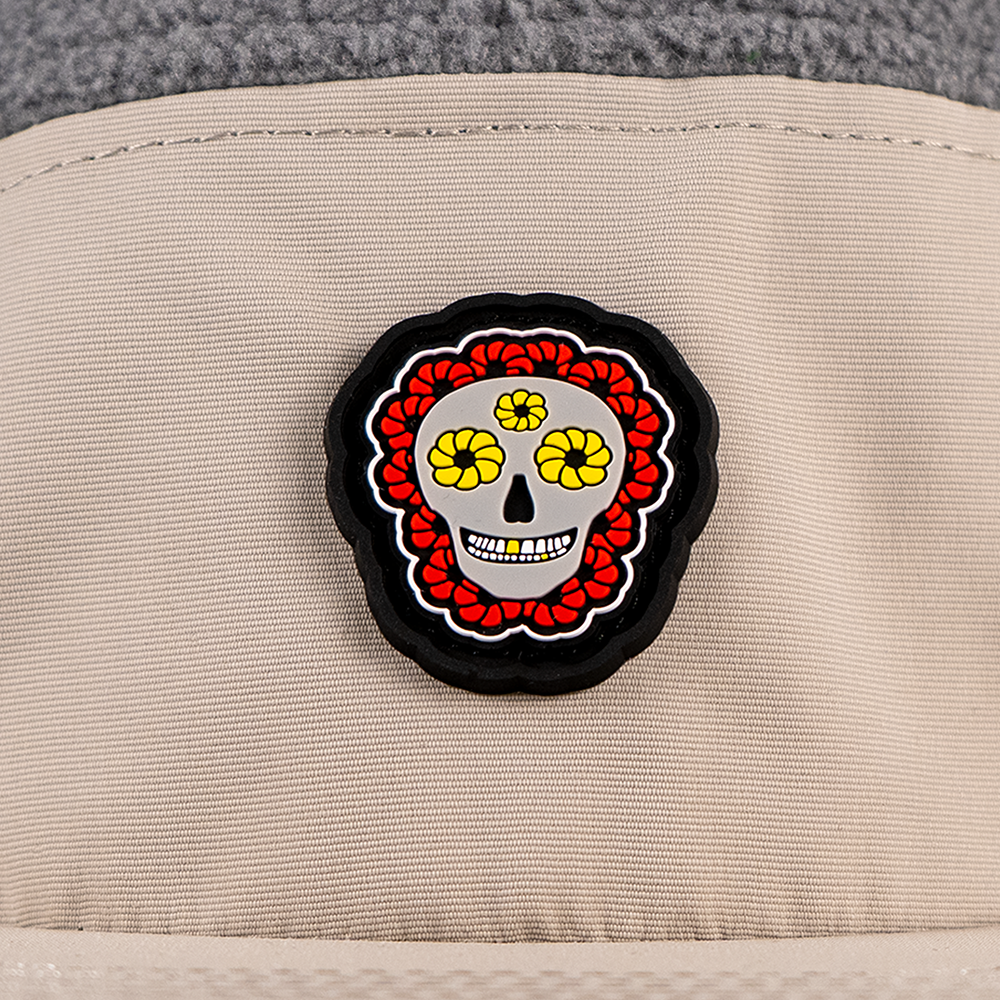 close-up of skull flower PVC patch detail on beige nylon panel