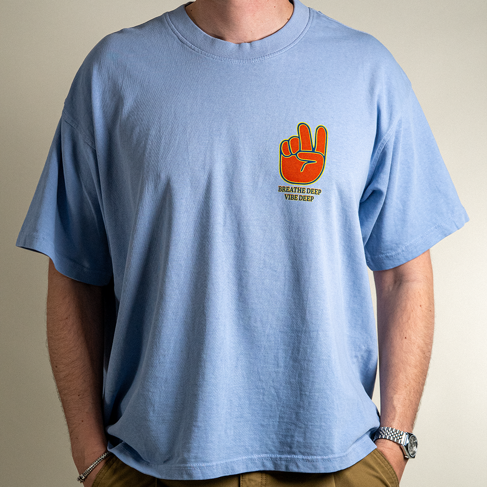 Close Up front view of model wearing Breathe Deep Vibe Deep heavyweight cotton tee.