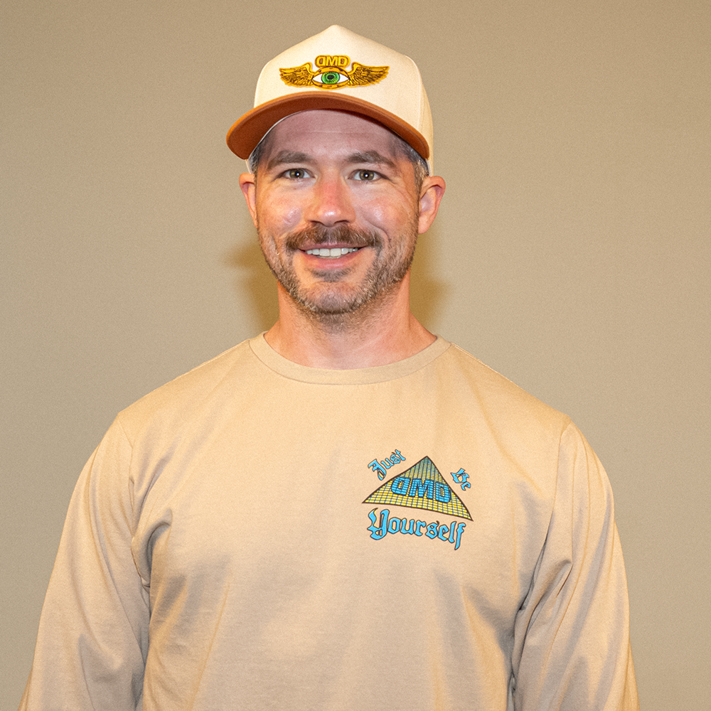 Front view of model wearing Pyramid of Success tee and front chest detail with “Just Be Yourself” DMD pyramid logo