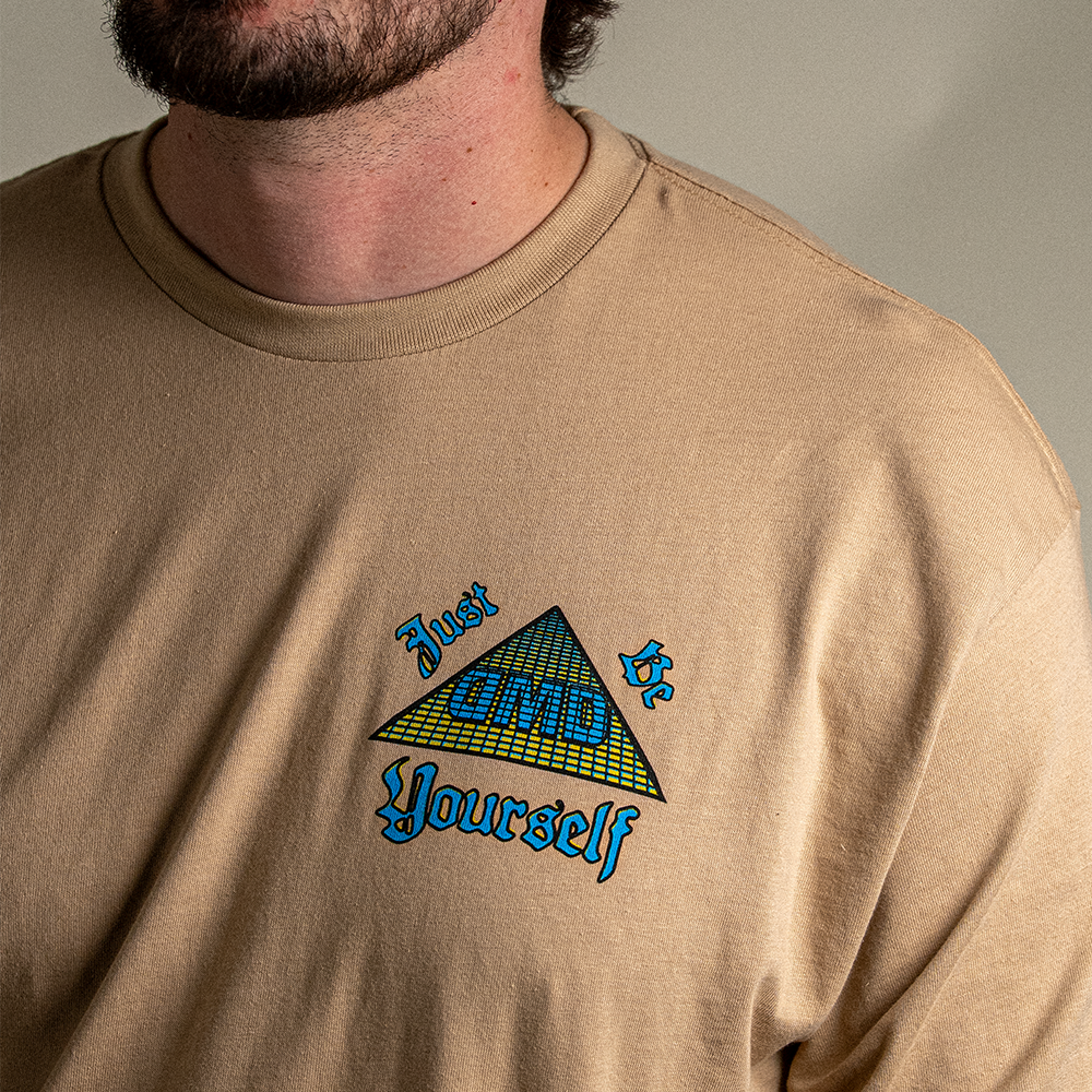 Front view of model wearing Pyramid of Success tee and front chest detail with “Just Be Yourself” DMD pyramid logo
