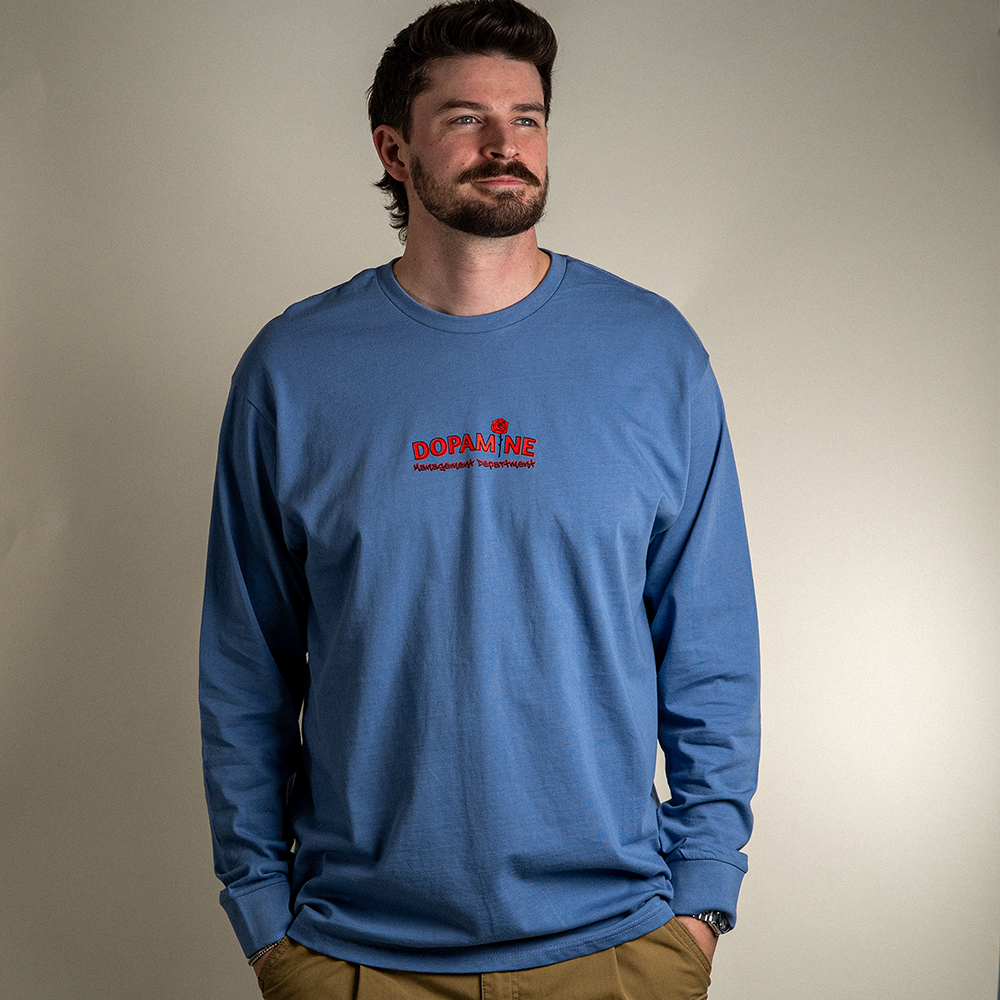 Model wearing Kindness Long Sleeve Tee – front chest Dopamine logo printed in red and black