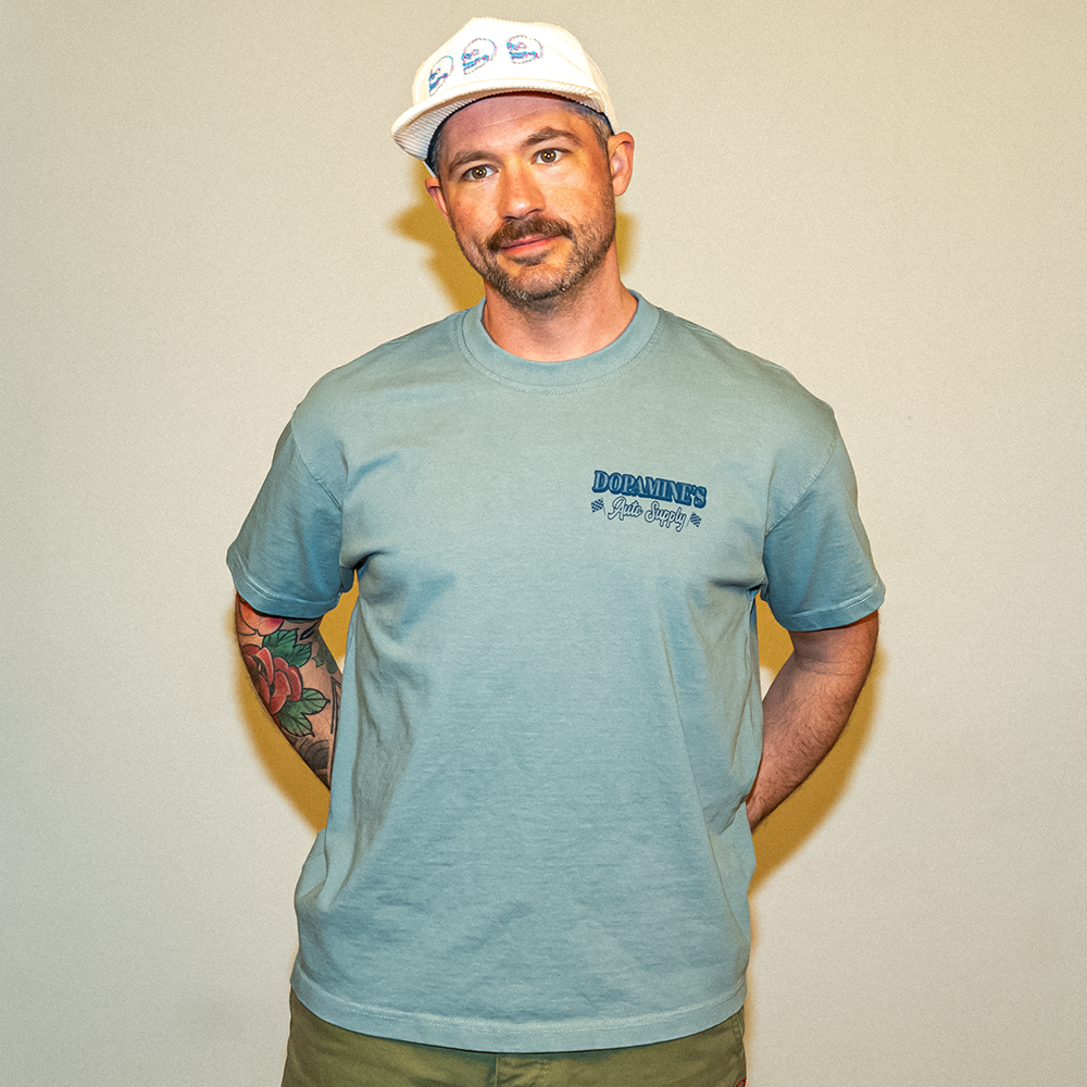 Model smiling in Under the Hood Tee – lifestyle shot