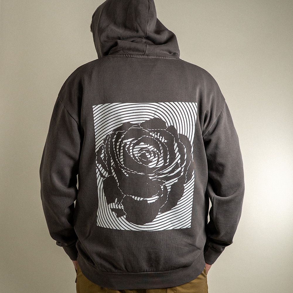 Back view of model with hood up on Rose fingerprint design on Rose Heavyweight hoodie.