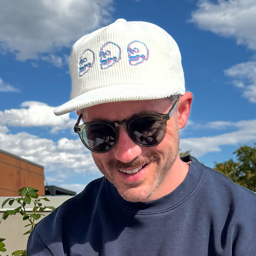 Model wearing Skulls Corduroy Hat outdoors with sunglasses