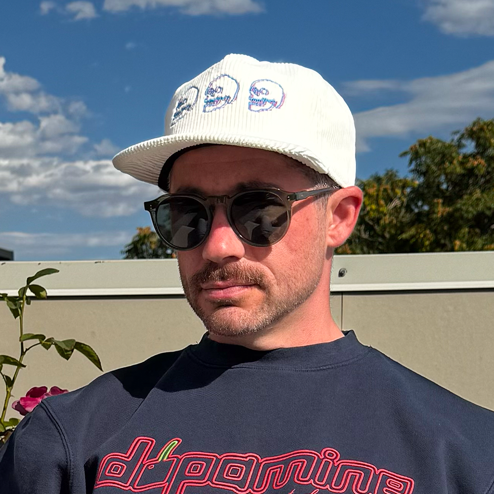 Model wearing Skulls Corduroy Hat outdoors with sunglasses