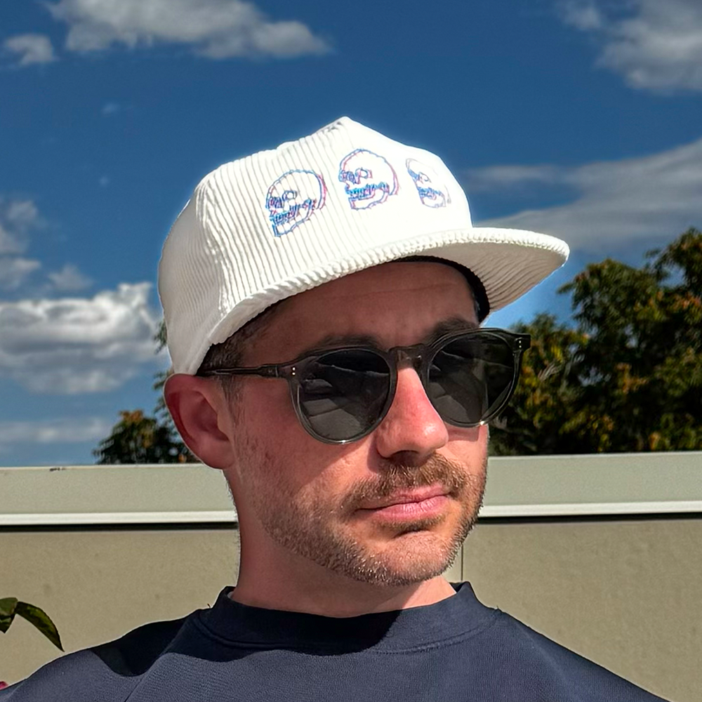 Model wearing Skulls Corduroy Hat outdoors with sunglasses