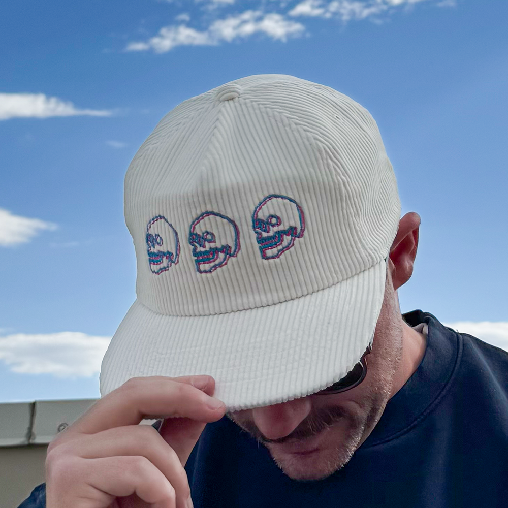 Model wearing Skulls Corduroy Hat outdoors with sunglasses