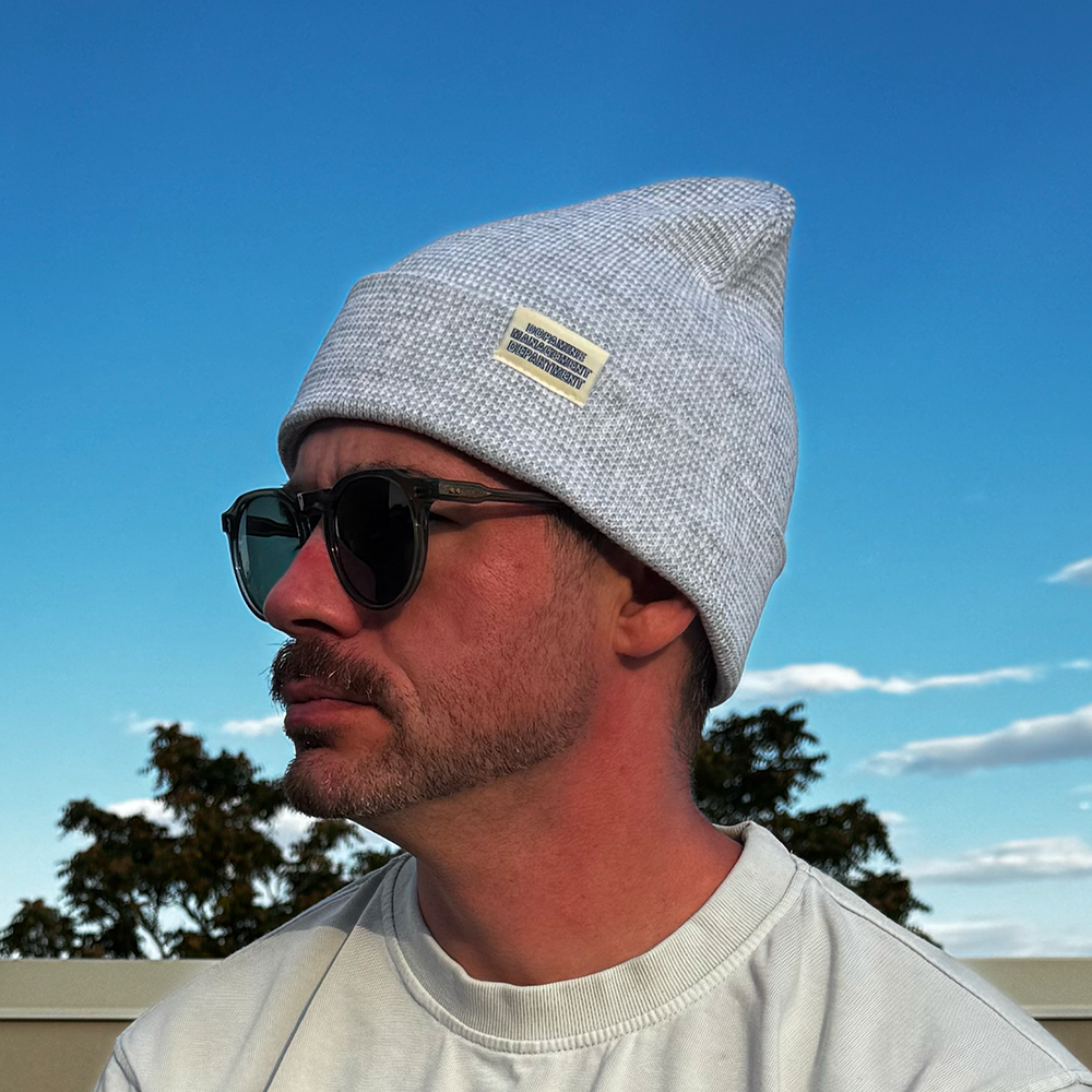 Model wearing Heather Beanie in grey & white with sunglasses