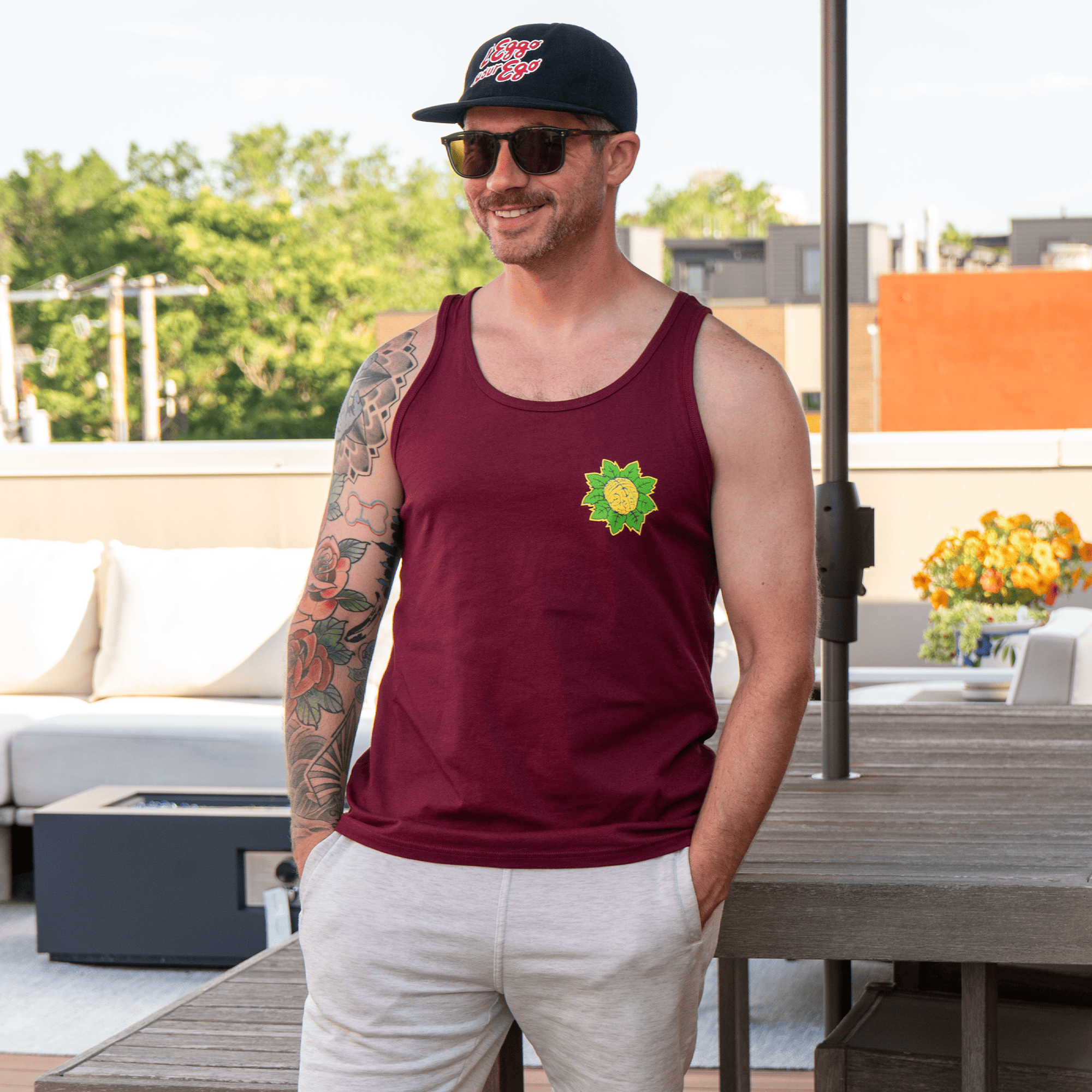 Model wearing Mindflower maroon cotton tank top on rooftop