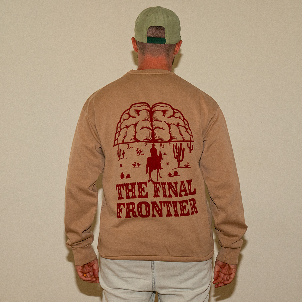 Back view of model in heavyweight crewneck showing red “The Final Frontier” graphic design