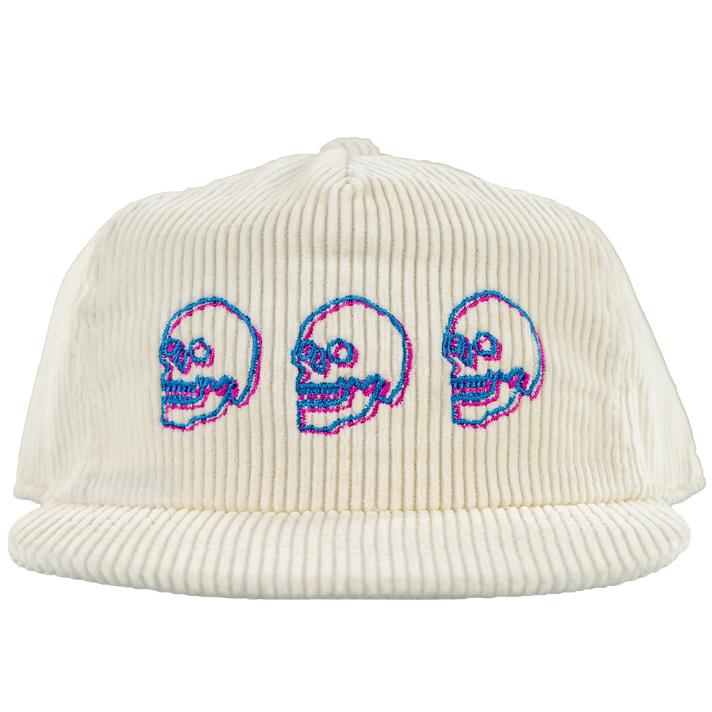 White corduroy snapback hat with embroidered neon skulls on front