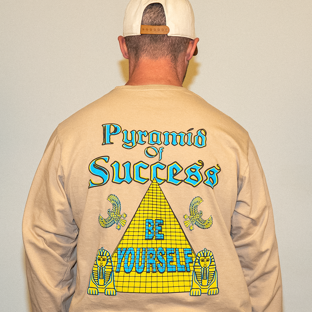 Close-up of yellow and blue pyramid design on tan cotton