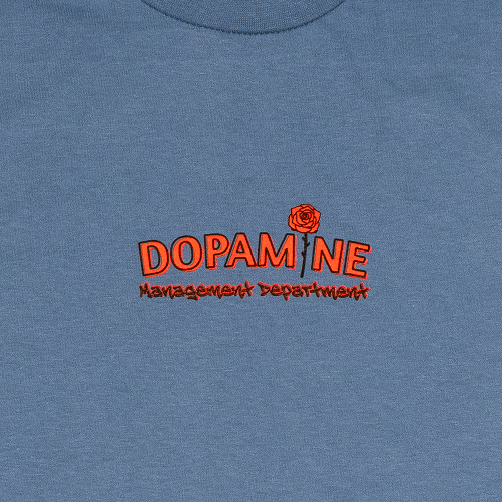 Front view of Kindness Long Sleeve Tee – Dopamine Management Department logo with rose detail on blue cotton long sleeve
