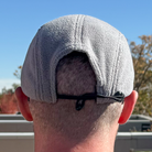 Back view of model wearing Skull Flower Fleece 5 Panel hat in natural outdoor light