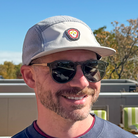 Front angled view of model wearing Skull Flower Fleece 5 Panel hat showing PVC skull flower patch