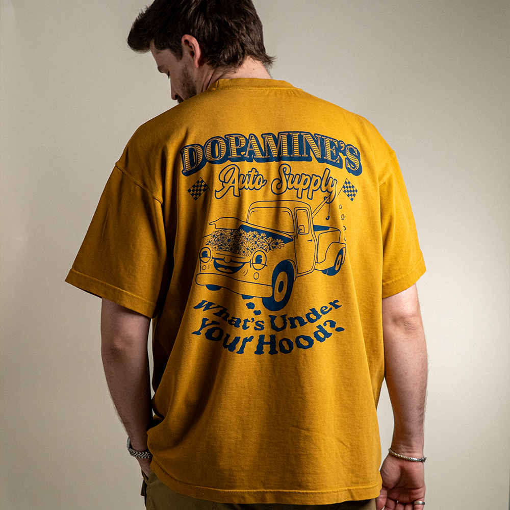Back view of model wearing 260 GSM heavyweight cotton t-shirt Under the Hood in peanut butter color