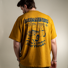 Back view of model wearing 260 GSM heavyweight cotton t-shirt Under the Hood in peanut butter color