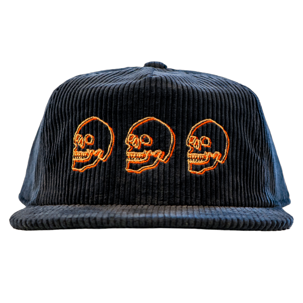 Navy blue cotton corduroy cap with cream and orange skull designs