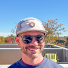 Front view of model wearing Skull Flower Fleece 5 Panel hat showing PVC skull flower patch