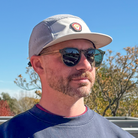 Front view of model wearing Skull Flower Fleece 5 Panel hat showing PVC skull flower patch