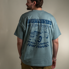 Back view of model wearing What's Under Your Hood Heavy Core Tee with oversized back design.