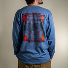 Model wearing blue Kindness Long Sleeve Tee – back graphic showing ‘Being Kind to Others’ repeating message