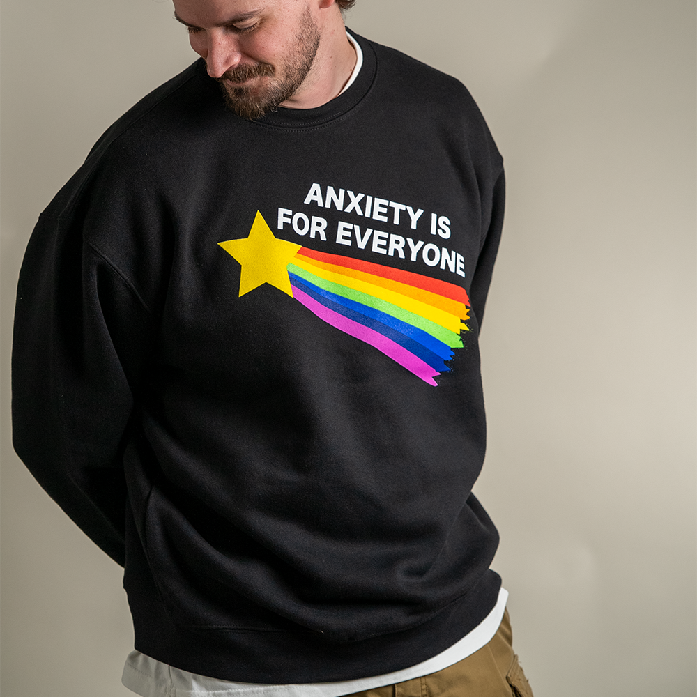 Model looking down wearing Anxiety is For Everyone crewneck sweatshirt in black