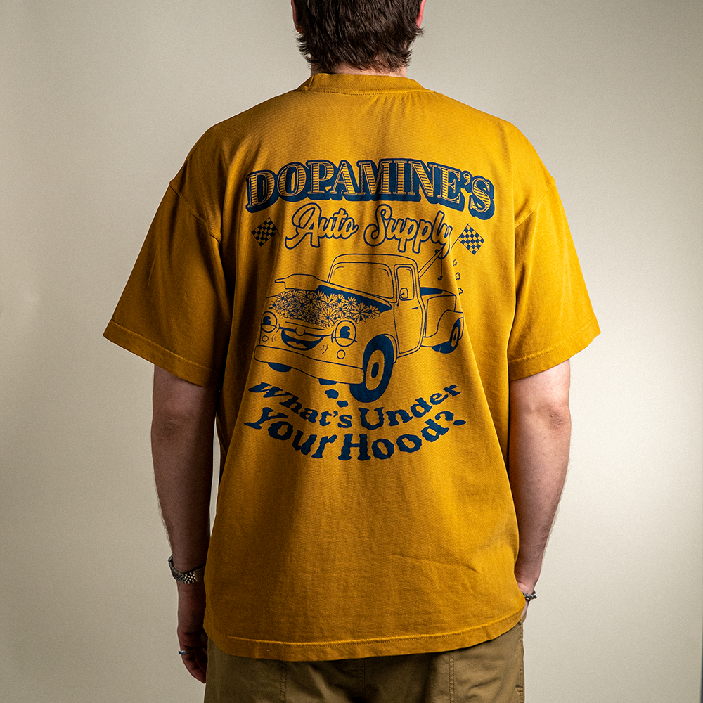 Back view of model wearing 260 GSM heavyweight cotton t-shirt Under the Hood in peanut butter color