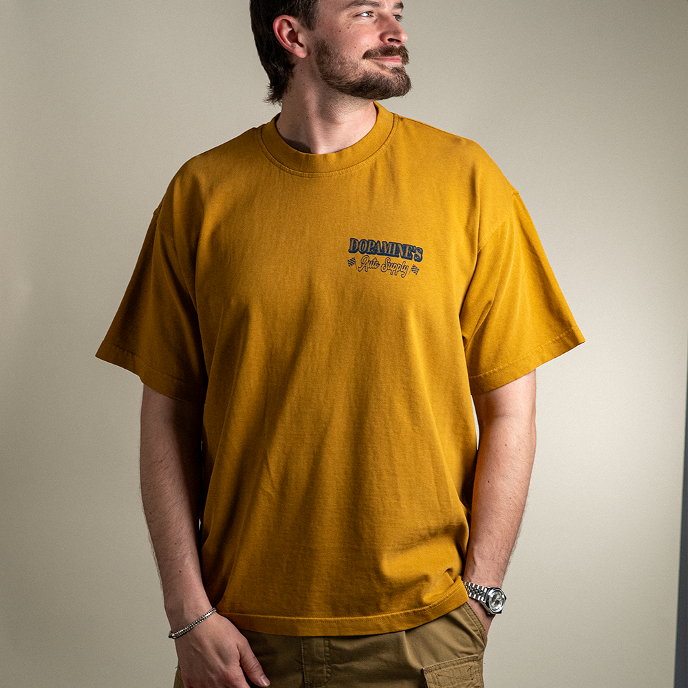 Front view of model wearing 260 GSM heavyweight cotton t-shirt Under the Hood in peanut butter color