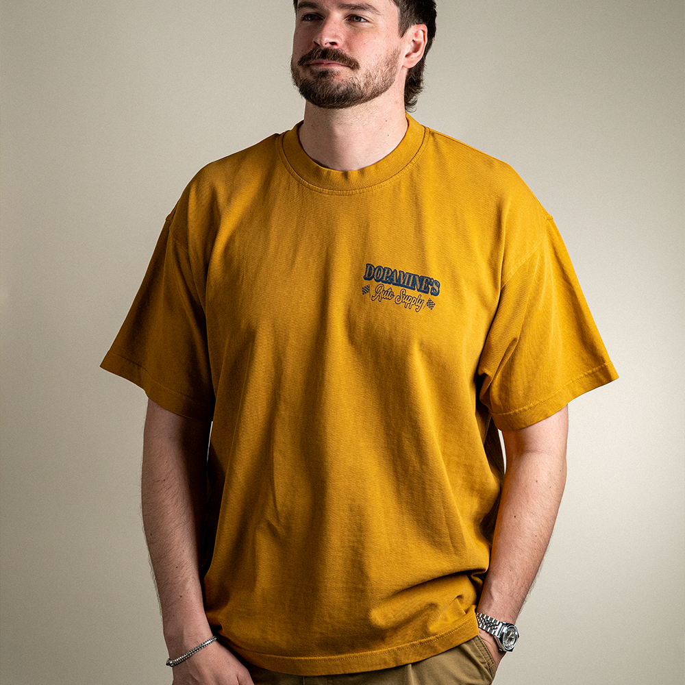 Front view of model wearing 260 GSM heavyweight cotton t-shirt Under the Hood in peanut butter color