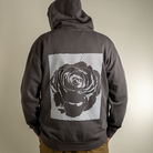 Back view of model with hood up on Rose fingerprint design on Rose Heavyweight hoodie. 