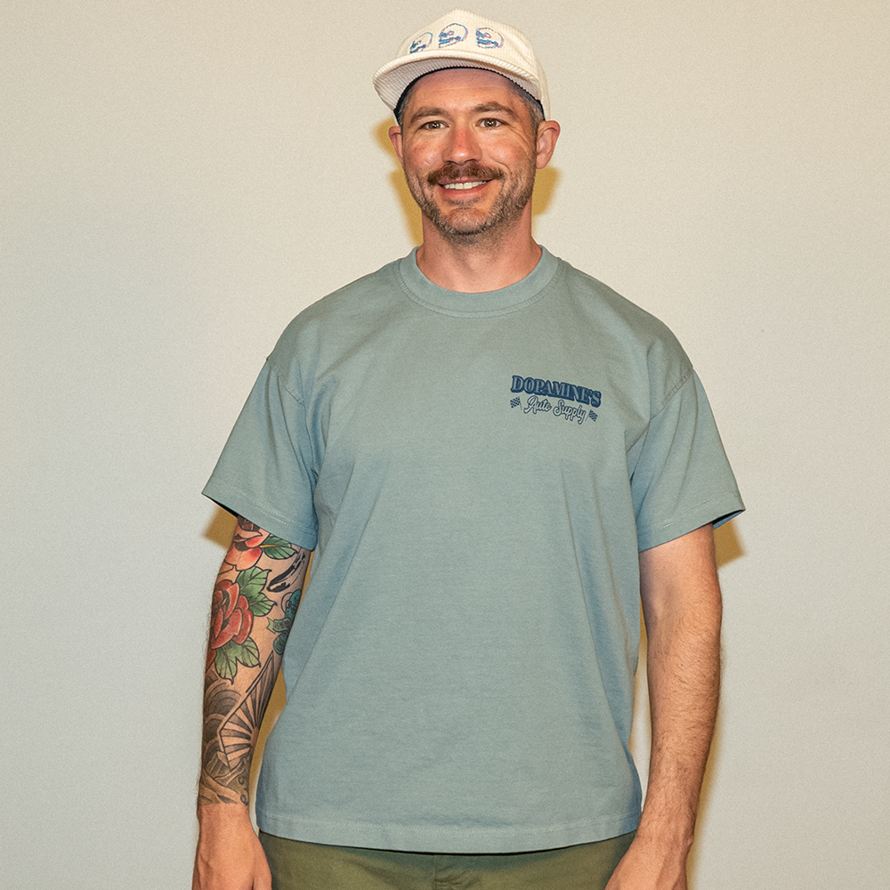 Model smiling in Under the Hood Tee – lifestyle shot