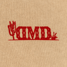 Detail shot of red DMD chest logo with cactus graphic on tan sweatshirt