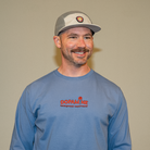 Model smiling in blue Kindness Long Sleeve Tee – unisex streetwear fit