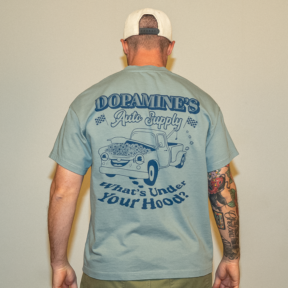 Model wearing Under the Hood Heavyweight Tee – back graphic view