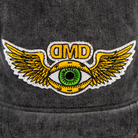 Close-up of embroidered flying third eye patch on vintage black DMD hat