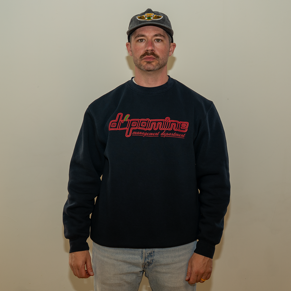 Model wearing navy cherry dopamine crewneck with casual jeans
