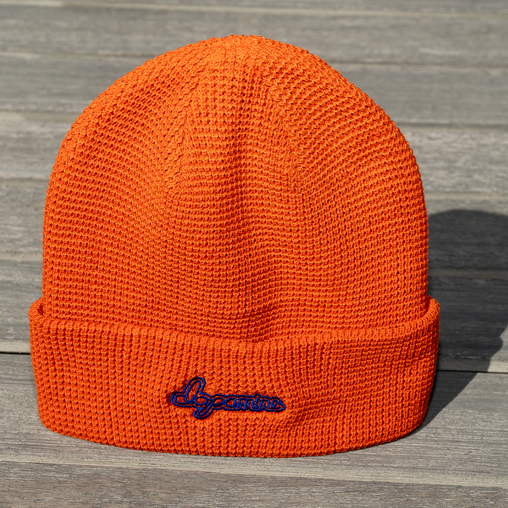 Orange Script Beanie with embroidered “dopamine” text – front view