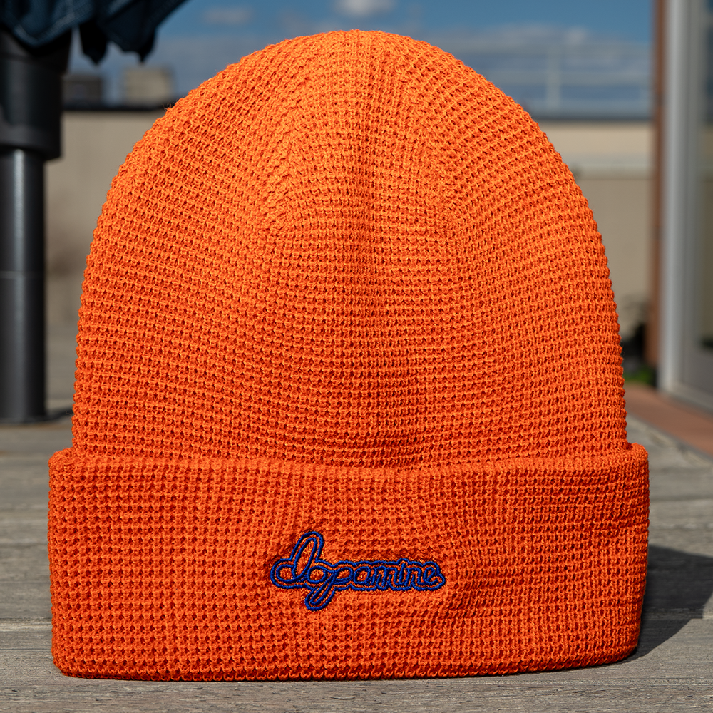 Orange Script Beanie with embroidered “dopamine” text – front view