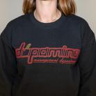 Front view of women’s black fleece sweatshirt with cherry dopamine graphic