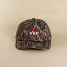 Front view organic cotton woodland camo snapback with red dōp patch